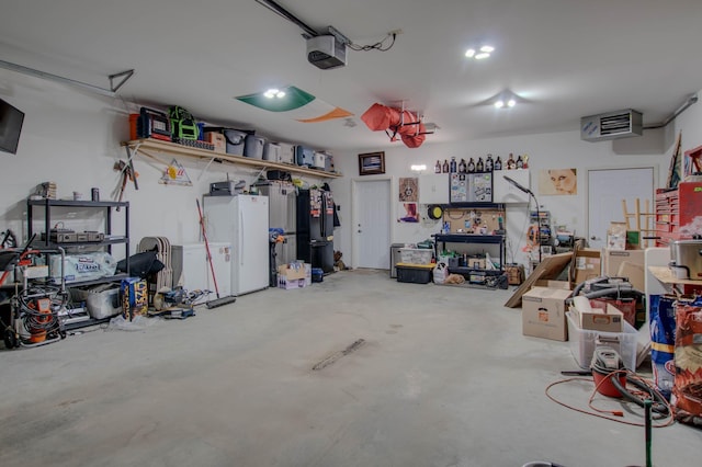 garage featuring freestanding refrigerator and a garage door opener