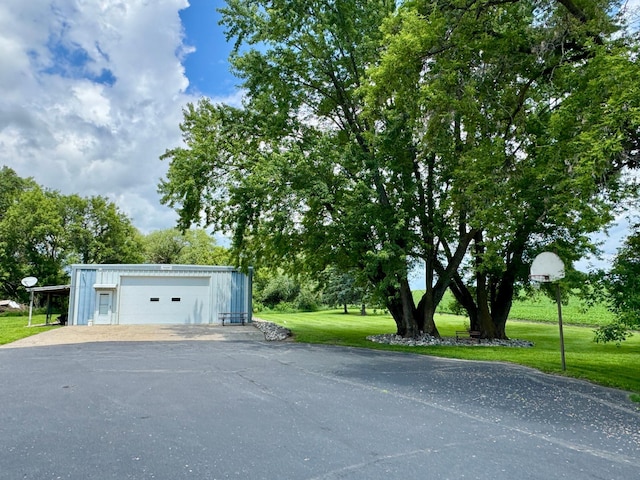 1001 1st Ave NW, Pelican Rapids, MN 56572 - detached garage featuring view of wooded area