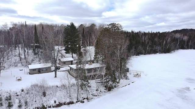 snowy aerial view featuring a view of trees