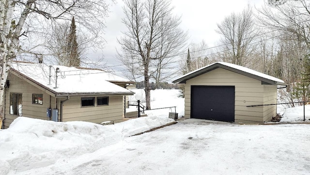 snow covered garage with a garage