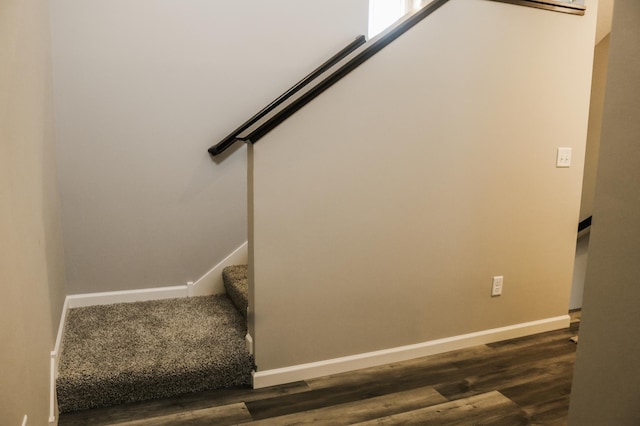 stairs featuring wood finished floors and baseboards