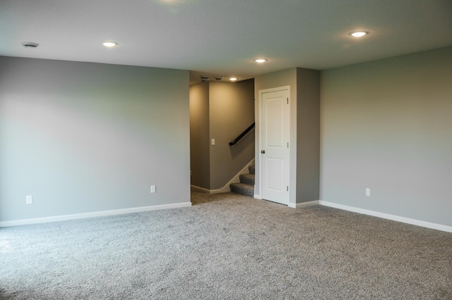 carpeted spare room with stairway, recessed lighting, and baseboards