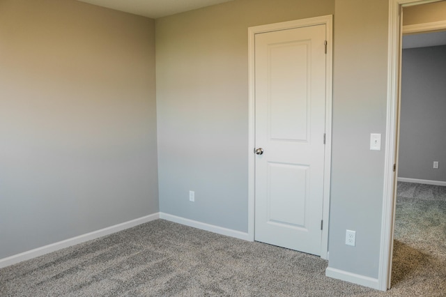 unfurnished bedroom featuring baseboards and carpet floors