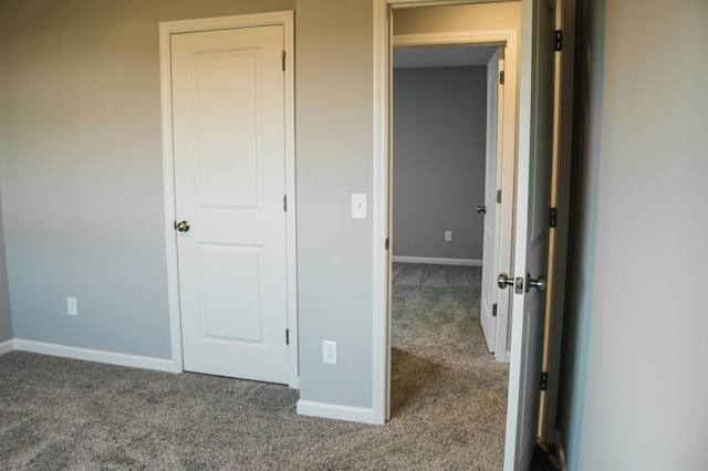 unfurnished bedroom featuring carpet and baseboards