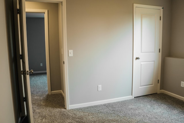 unfurnished bedroom with baseboards and carpet flooring