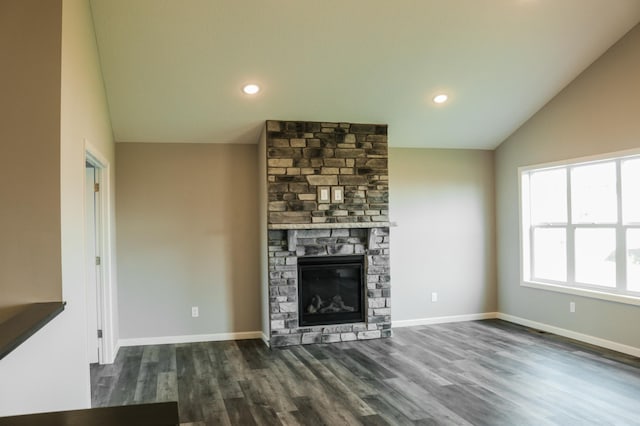 unfurnished living room with baseboards, lofted ceiling, dark wood-type flooring, and a fireplace