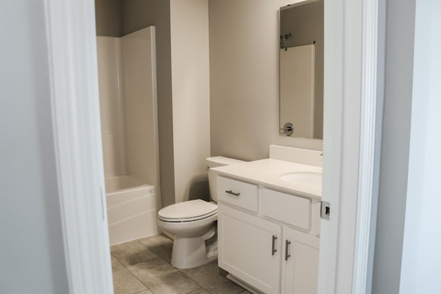 bathroom featuring tub / shower combination, toilet, vanity, and tile patterned floors