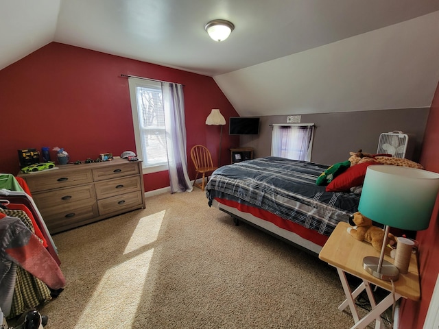 bedroom with vaulted ceiling, baseboards, and light carpet