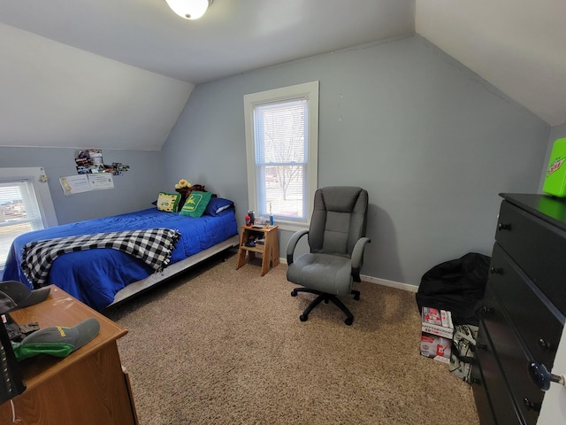 bedroom featuring lofted ceiling, baseboards, and carpet floors