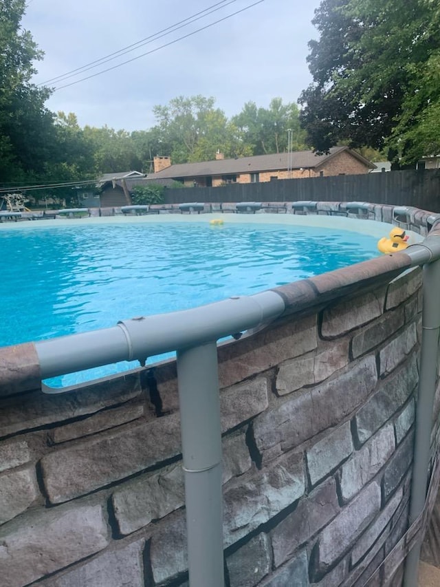 view of swimming pool with a fenced in pool and fence