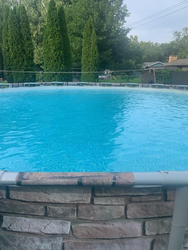 view of swimming pool featuring a fenced in pool and fence