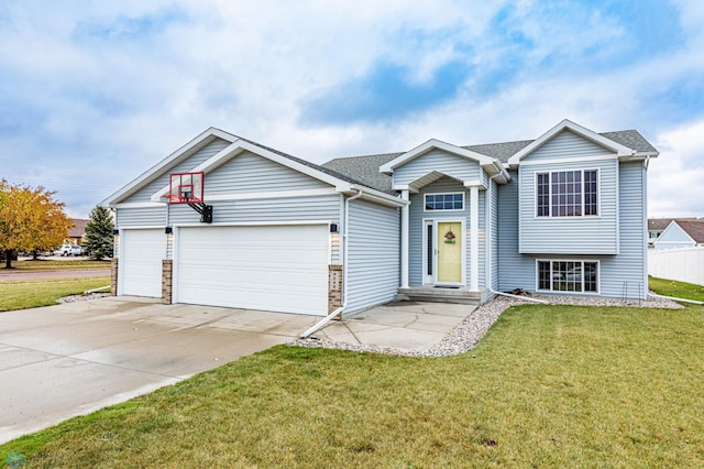 view of front facade featuring a front yard, concrete driveway, an attached garage, and a shingled roof