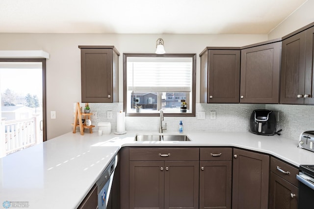 kitchen featuring a sink, tasteful backsplash, and light countertops