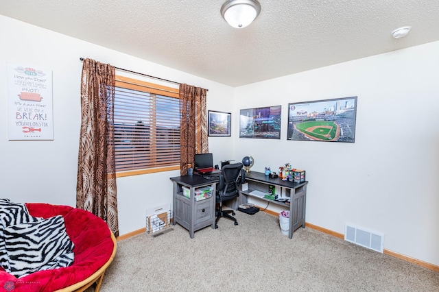 office space with carpet flooring, baseboards, visible vents, and a textured ceiling