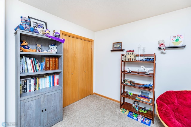 playroom featuring baseboards and carpet