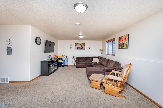 living area with visible vents, baseboards, carpet, and a textured ceiling