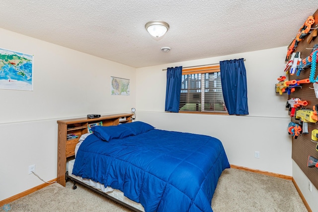 carpeted bedroom with baseboards and a textured ceiling