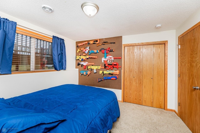 bedroom with visible vents, baseboards, carpet flooring, a closet, and a textured ceiling