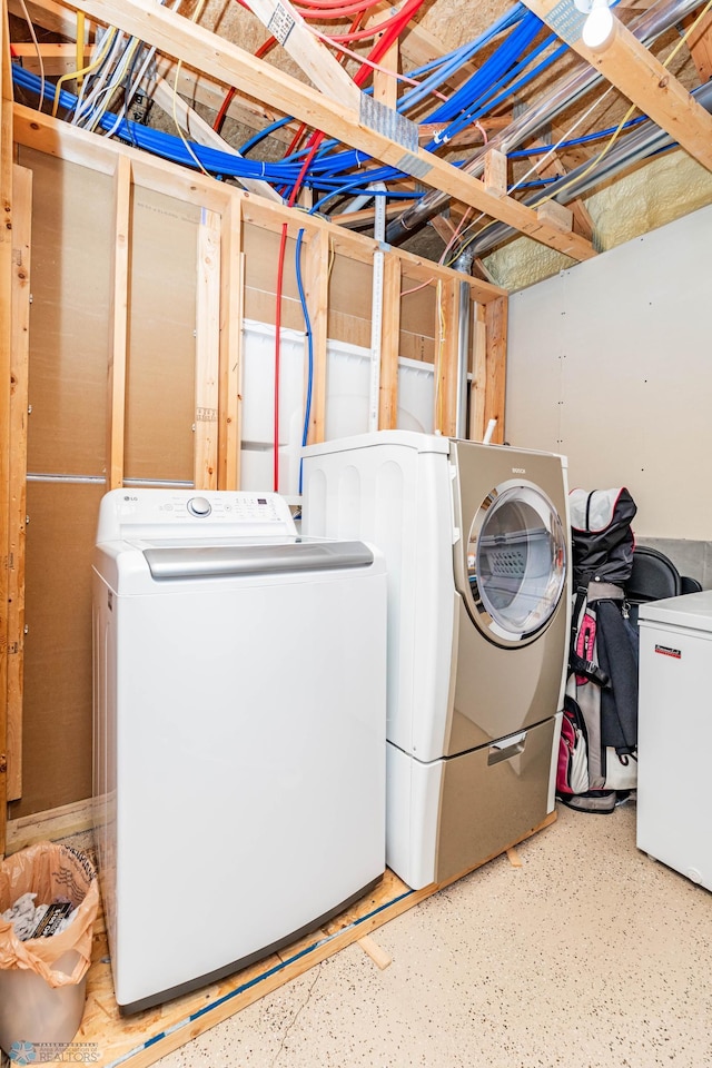 laundry room with washer and dryer and laundry area