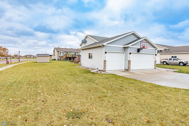 view of side of home with a garage, driveway, and a yard