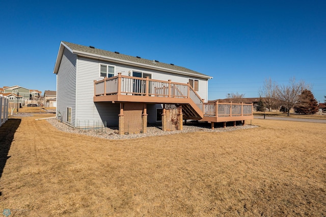 back of house with a lawn, fence, and a wooden deck