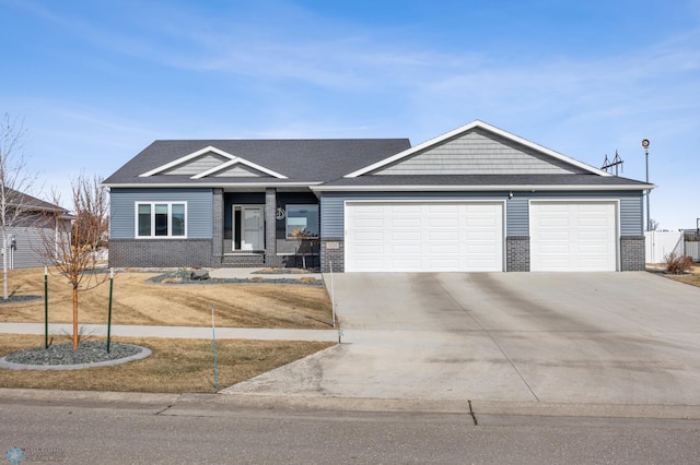 view of front facade featuring concrete driveway, an attached garage, and brick siding