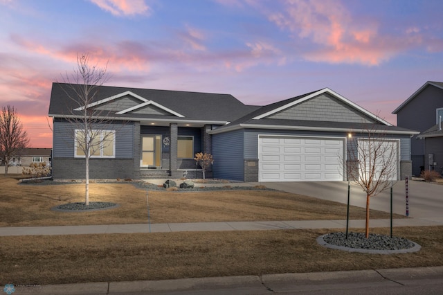 view of front of home with brick siding, concrete driveway, and an attached garage