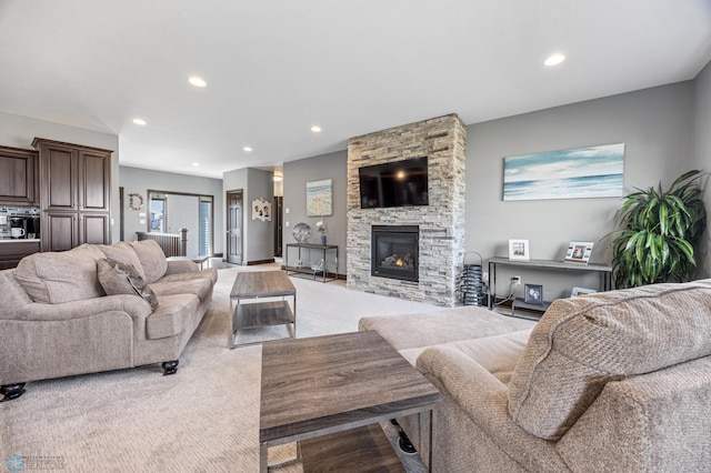 living room with recessed lighting, light colored carpet, and a fireplace