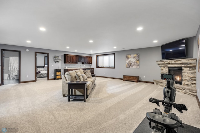 living room featuring light carpet, recessed lighting, and baseboards