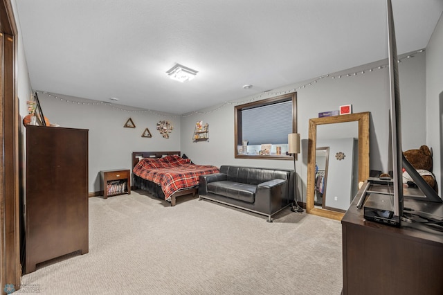 bedroom with baseboards and carpet