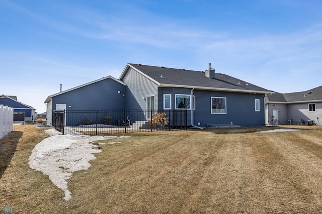 back of property with a patio, fence, a lawn, and a chimney