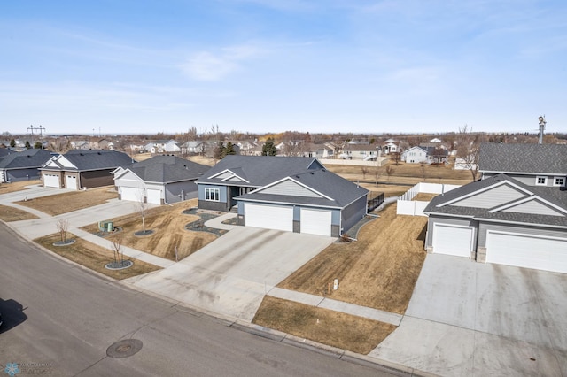 view of front facade with a garage, a residential view, concrete driveway, and fence