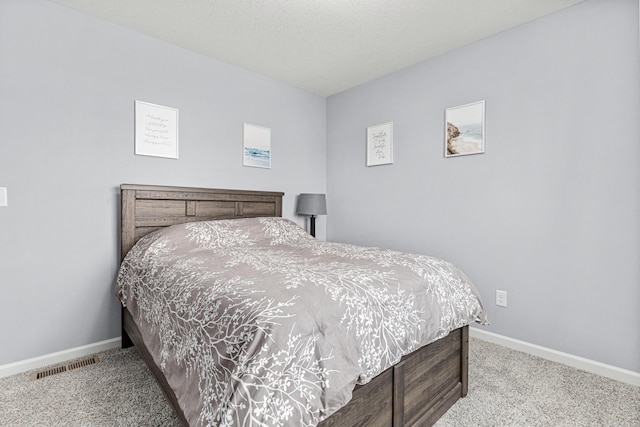 bedroom with visible vents, baseboards, and carpet
