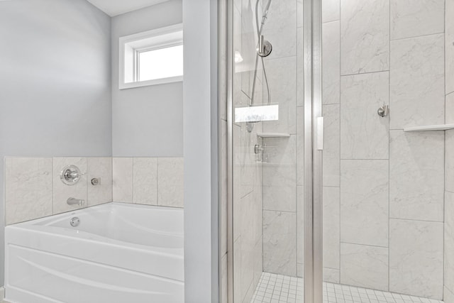 full bathroom featuring a shower stall and a bath