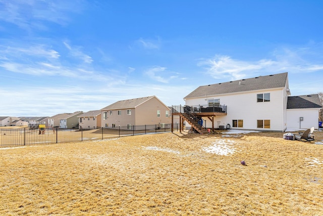 back of property featuring a wooden deck, a fenced backyard, stairway, a patio, and a residential view
