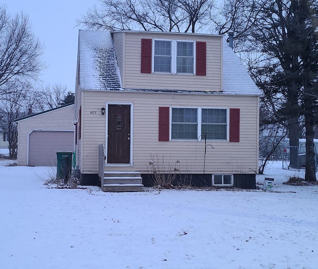 view of front facade featuring entry steps, a detached garage, and an outdoor structure