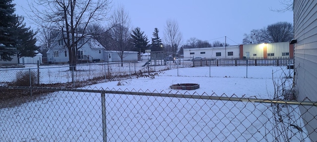 yard covered in snow with a fire pit and fence private yard