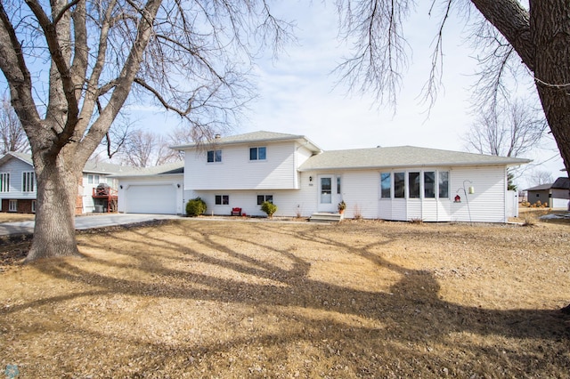 split level home with a garage and driveway