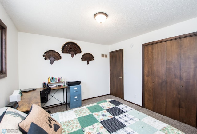 carpeted bedroom with a closet, visible vents, a textured ceiling, and baseboards