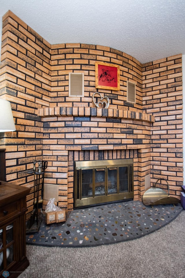 room details with carpet flooring, a fireplace, and a textured ceiling