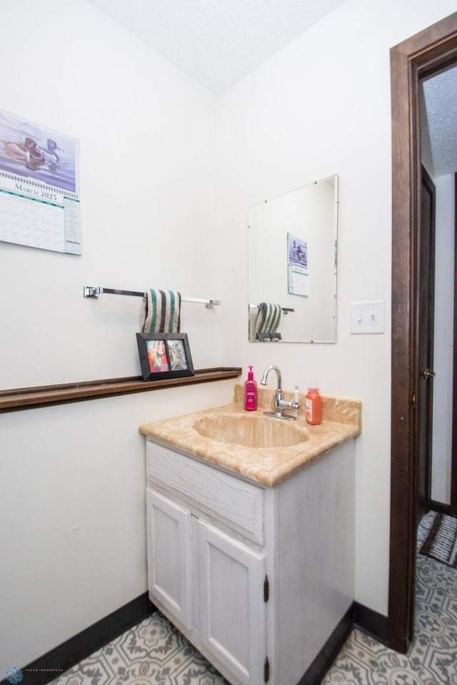 bathroom featuring vanity and baseboards