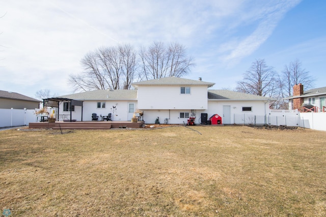 rear view of property with a deck, a yard, and a fenced backyard