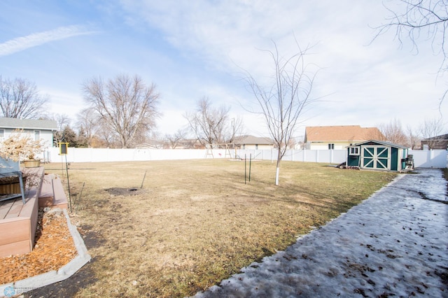 view of yard with an outbuilding, a storage shed, and a fenced backyard