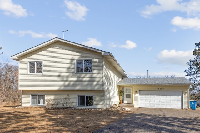 view of front facade with gravel driveway and a garage