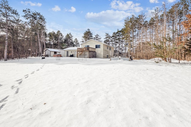 yard covered in snow featuring an outdoor structure