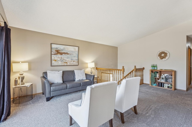 carpeted living room featuring lofted ceiling and baseboards