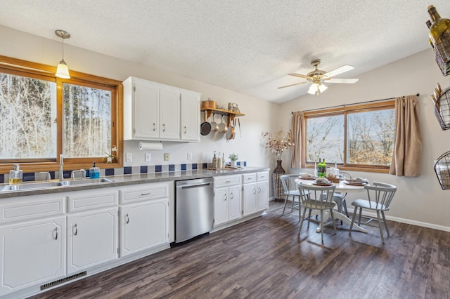 kitchen featuring visible vents, a ceiling fan, a sink, stainless steel dishwasher, and lofted ceiling