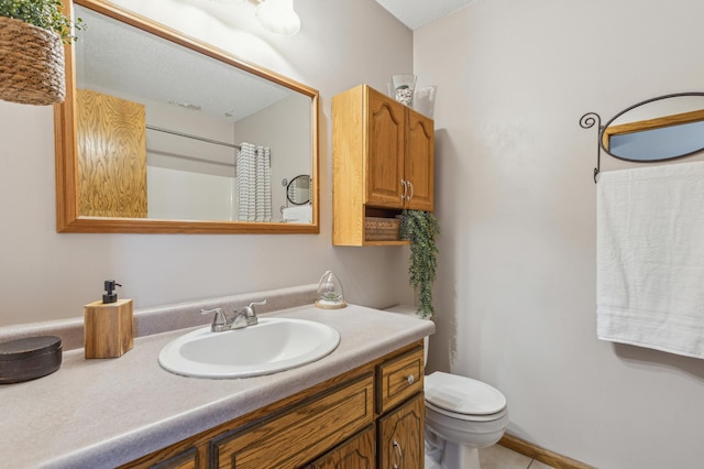 full bathroom with baseboards, toilet, and vanity