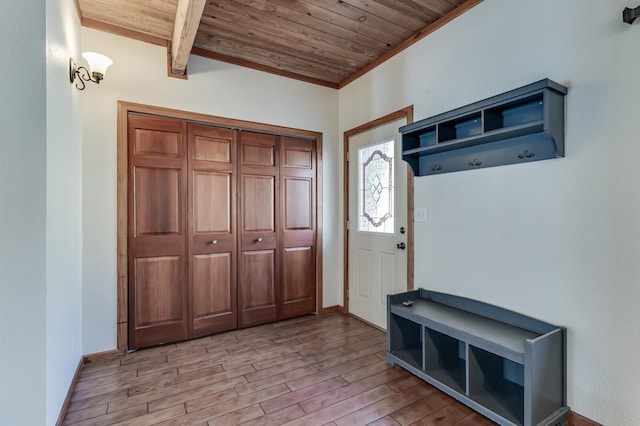 entrance foyer featuring wooden ceiling, light wood-style floors, and baseboards