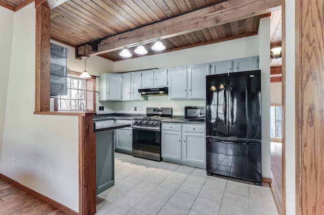 kitchen with dark countertops, baseboards, under cabinet range hood, beam ceiling, and black appliances